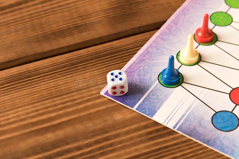 Multicolored Game Chips with Dice on the Playing Board. Board Game