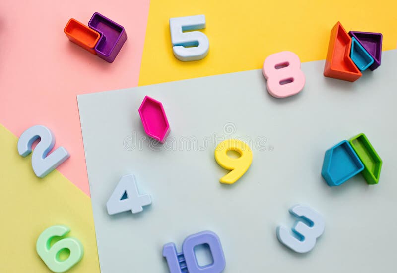 Multi-colored numbers on a yellow background top view. Child Development Concept.