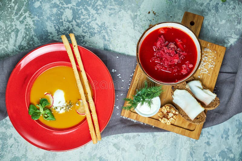 Multicolored Plates with Different Soups. Gray Light Textured