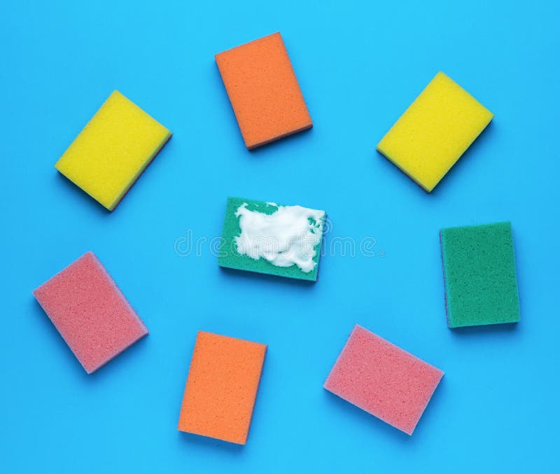 Multicolored Set of Bright Foam Sponges on a Blue Background. Minimal