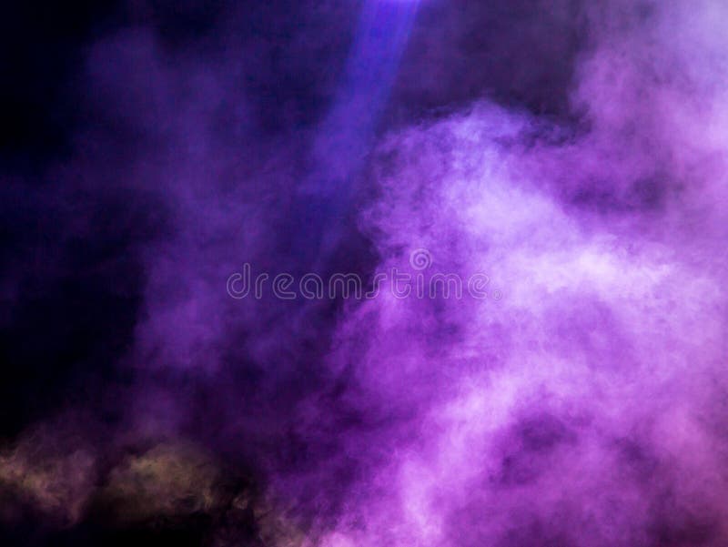 Multi-colored smoke at the concert at night