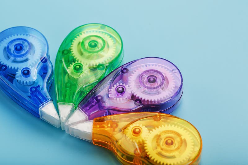 Stationery Correction Tapes are Multicolored on a Blue Background Stock