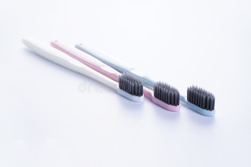 Multicolored Toothbrushes with Black Bristles on a White Background