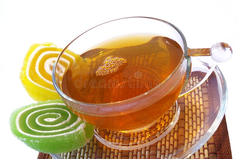 Multi-coloured fruit candy and cup of tea