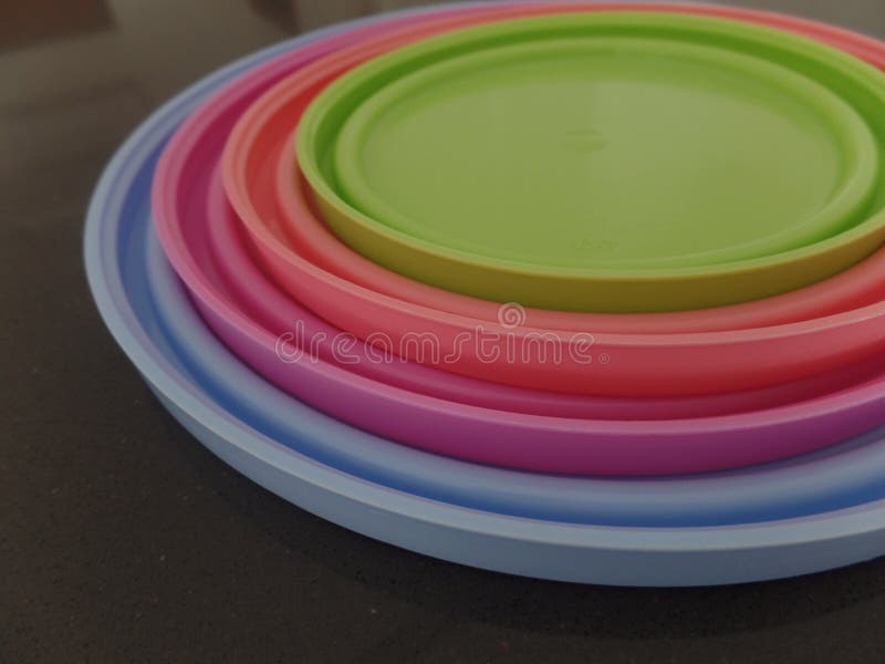 Multi coloured round plastic lids stock image
