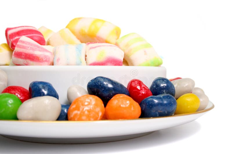 Multi-coloured sweets of two kinds in a plate