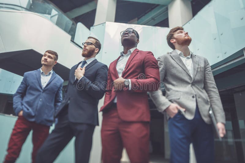 Multi-Cultural Office Staff Standing In Lobby. professional business team royalty free stock image Multi-Cultural Office Staff Standing In Lobby. professional business team royalty free stock image