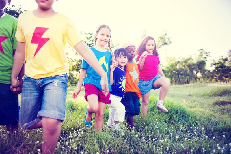 Multi-Ethnic Children Walking Together Through the Field. Happy multiethnic boys stock images, royalty-free photos and pictures