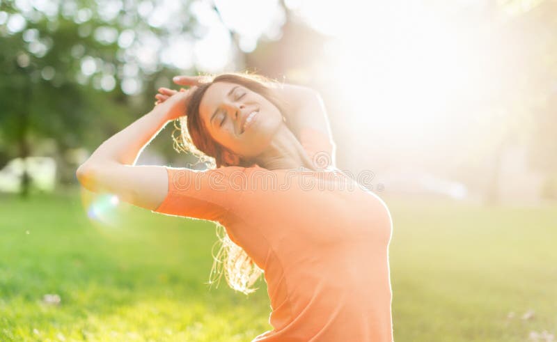 Multi-ethnic girl enjoying the warmth of a sunset