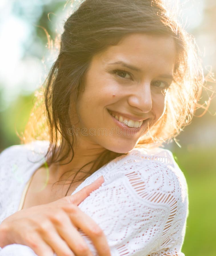 Multi-ethnic girl enjoying the warmth of a sunset