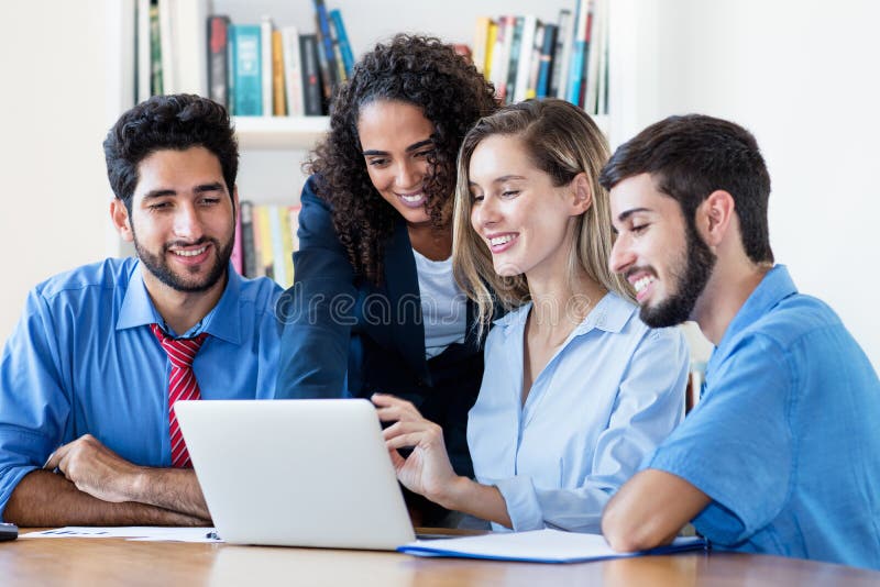 Multi ethnic group of software engineers and programmers at computer stock photos