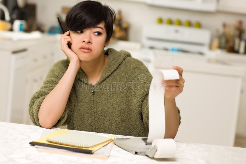 Multi-ethnic Young Woman Agonizing Over Financials