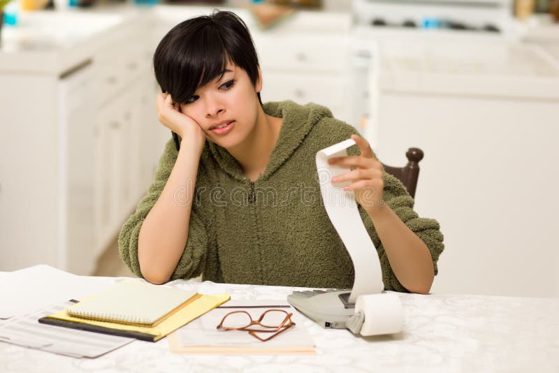 Multi-ethnic Young Woman Agonizing Over Financials