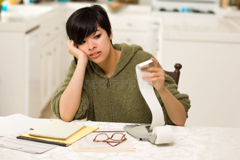 Multi-ethnic Young Woman Agonizing Over Financials royalty free stock image Multi-ethnic Young Woman Agonizing Over Financials royalty free stock image