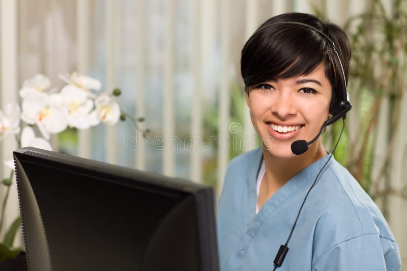 Multi-ethnic Young Woman With Headset and Scrubs