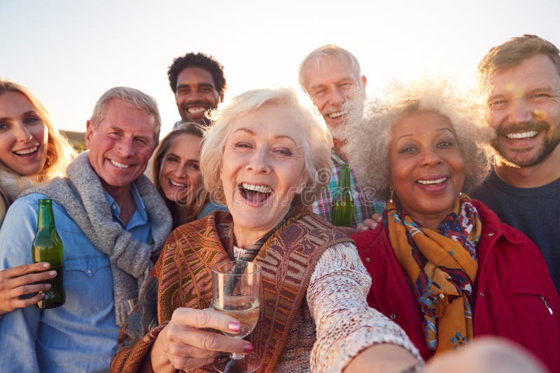Multi-Generation Adult Family Taking Selfie At Outdoor Party Celebration royalty free stock photos