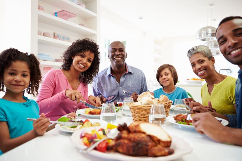 Multi Generation African American Family Eating Meal At Home Stock