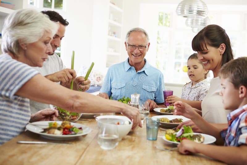 Multi Generation Family Eating Meal Around Kitchen Table royalty free stock photos Multi Generation Family Eating Meal Around Kitchen Table royalty free stock photos