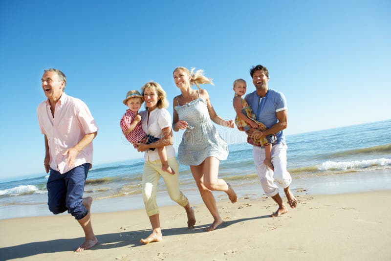 Multi Generation Family Enjoying Beach Holiday Stock Image - Image of