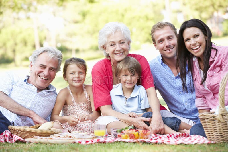 Multi Generation Family Enjoying Picnic Together royalty free stock photos Multi Generation Family Enjoying Picnic Together royalty free stock photos
