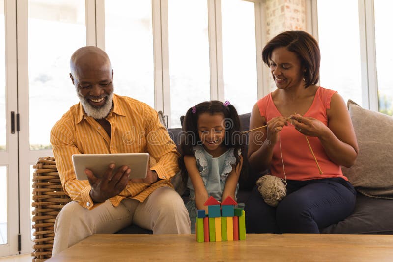 Multi-generation family enjoying their free time in living room royalty free stock photos Multi-generation family enjoying their free time in living room royalty free stock photos