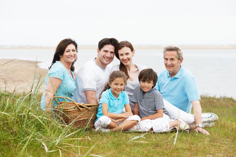 Multi Generation Family Having Picnic By Sea stock images Multi Generation Family Having Picnic By Sea stock images