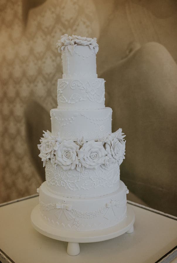 Multistory White Wedding Cake Decorated with White Flowers Stock Image