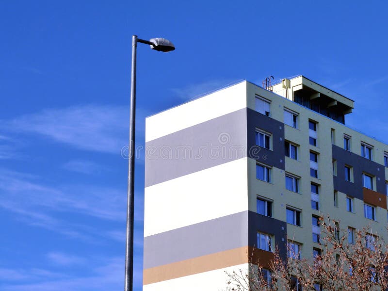 Multi level horizontally striped bright stucco finished apartment building