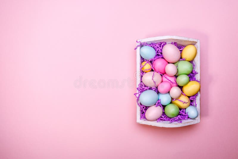 Multicolor eggs in a white tray. Creative Easter concept. Modern stock photo