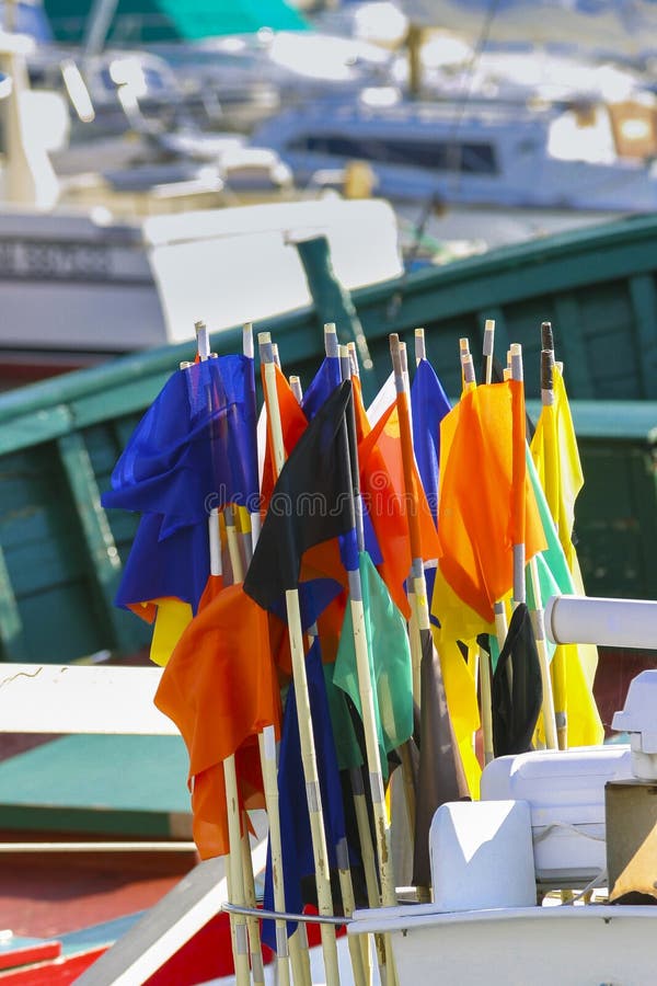 Multicolor Net Marker Flags on a Traditional Fishing Boat Stock Photo