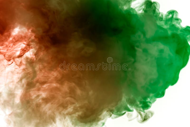 Multicolor, thick smoke, illuminated by colored in green and red light against a white isolated background, welded with clubs and royalty free stock photo Multicolor, thick smoke, illuminated by colored in green and red light against a white isolated background, welded with clubs and royalty free stock photo