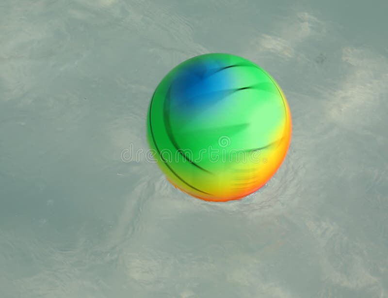 Multicolored Ball Spinning in the Pool with Blur Effect Stock Photo