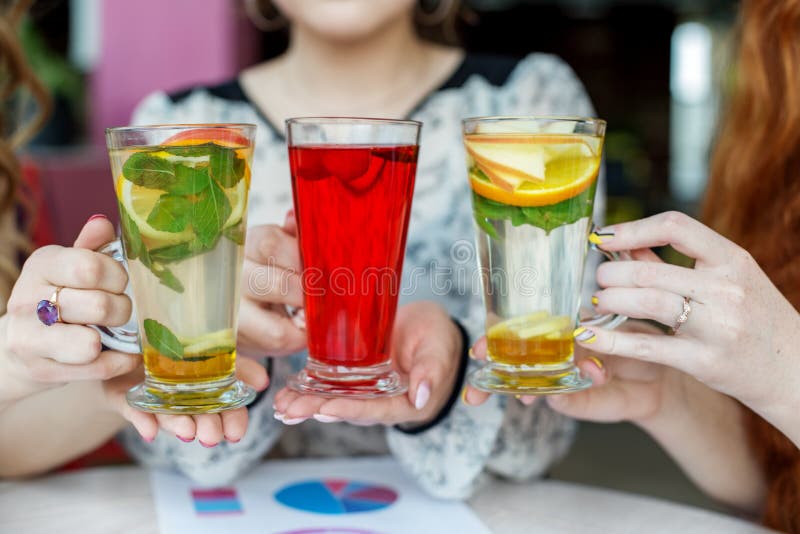 Multicolored delicious cocktails in female hands. Concept of drinks, meeting, fun and party stock image Multicolored delicious cocktails in female hands. Concept of drinks, meeting, fun and party stock image