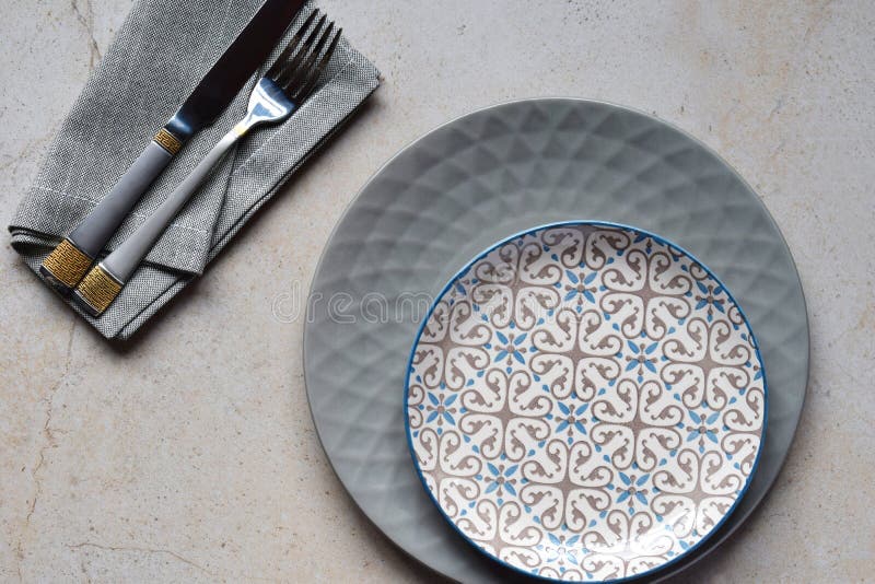 Multicolored empty ceramic plates and bowls on a marble background. Table setting. Shabby chic or retro style. Copy space. Mock up stock photo Multicolored empty ceramic plates and bowls on a marble background. Table setting. Shabby chic or retro style. Copy space. Mock up stock photo