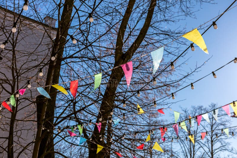 Multicolored Flags Hanging on Tree. Decoration Outdoor Party. Stock