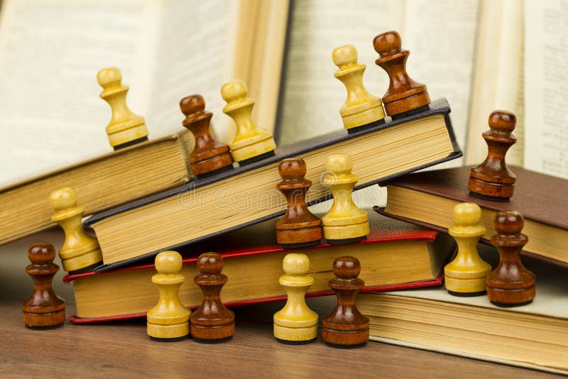 Multicolored old books and chess pieces