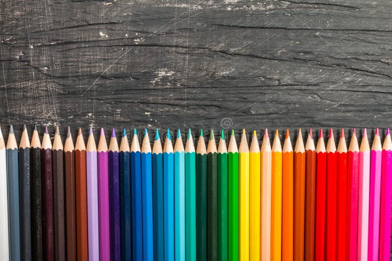 Multicolored pensils and chalk board