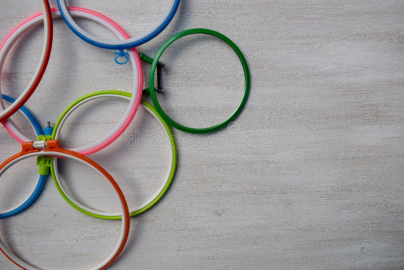 Multicolored Plastic Embroidery Hoops for Creative Art on a Light Background. View from Above