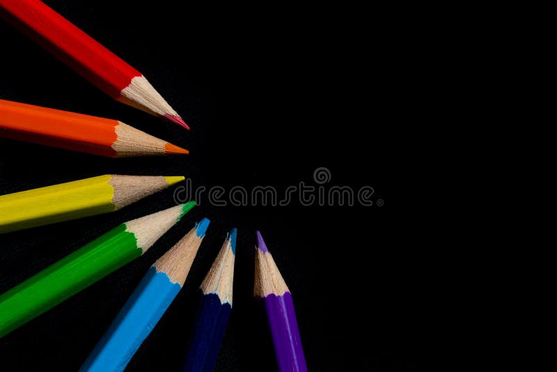 Multicolored rainbow pencils. Coloured pencils isolated on black background close up. Top view. Macro Photography. Pencils Wallpap