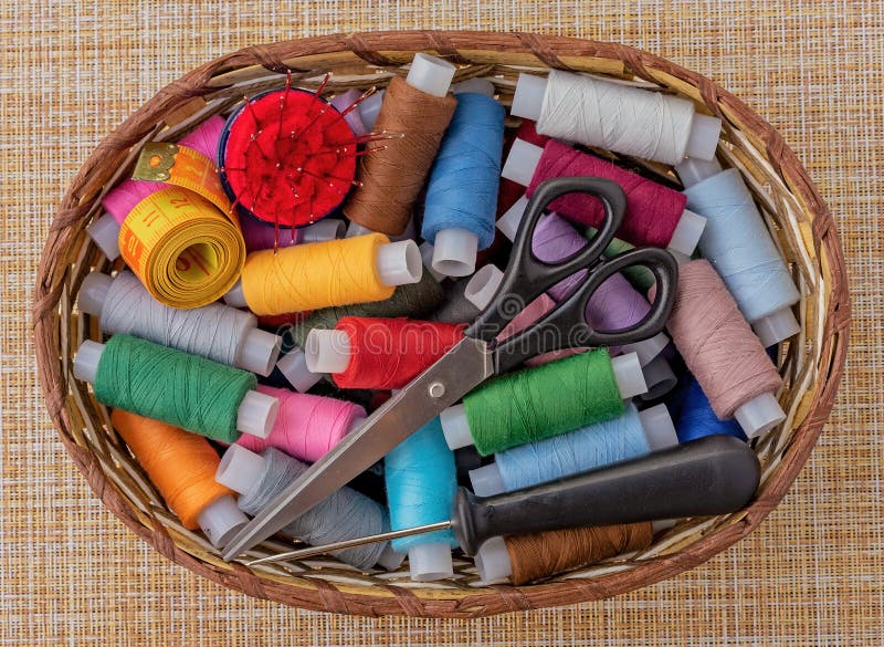 Multicolored Sewing Threads in a Wicker Basket. Spools of Thread for