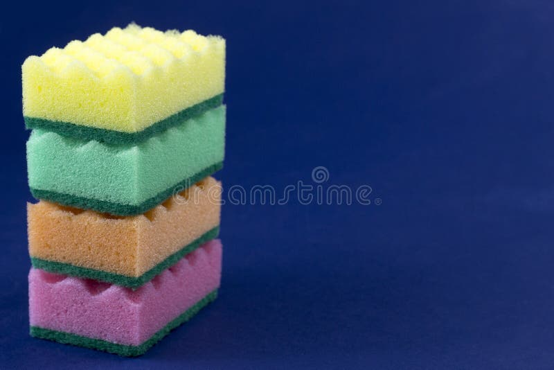 Multicolored sponges for washing on a blue background kitchen stock photos Multicolored sponges for washing on a blue background kitchen stock photos