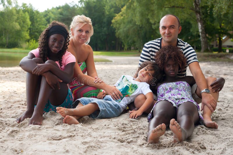 Multicultural family on the beach stock photos Multicultural family on the beach stock photos