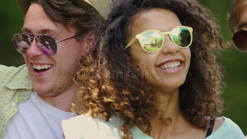 Multicultural group of friends enjoying music festival outdoors, happiness