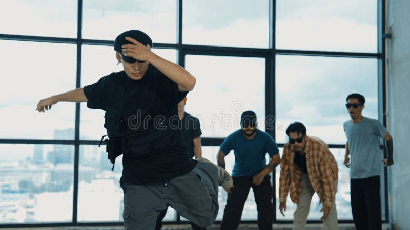 Multicultural hipster looking at camera while perform break dancing. Hiphop. royalty free stock photos