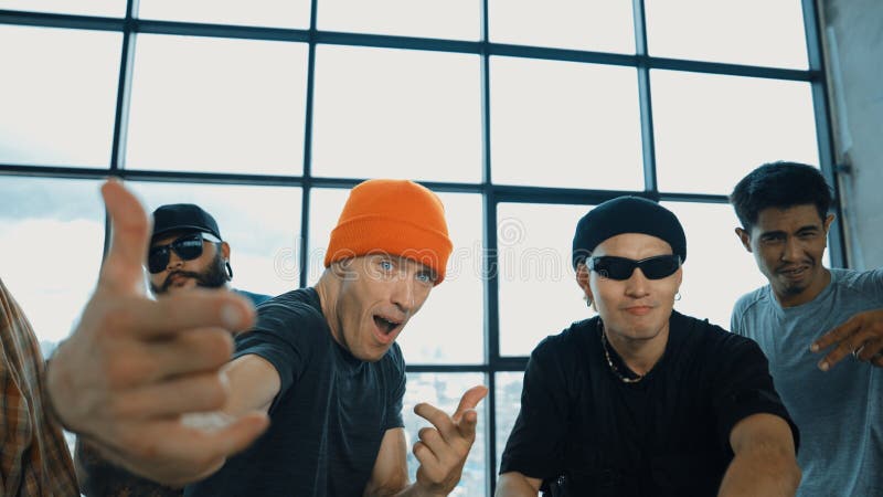 Multicultural hipster looking at camera while perform break dancing. Hiphop. royalty free stock photos