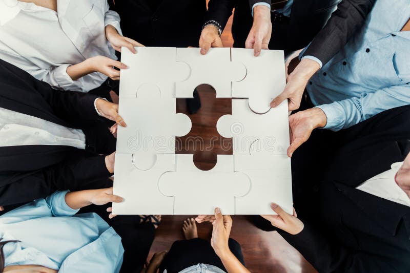 Multiethnic business people holding jigsaw pieces together. Meticulous stock images