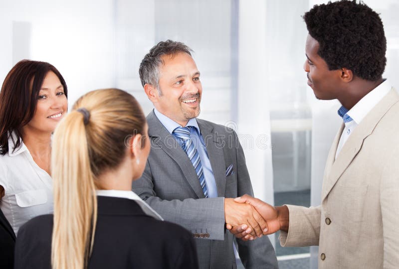 Multiethnic businesspeople shaking hand stock photos