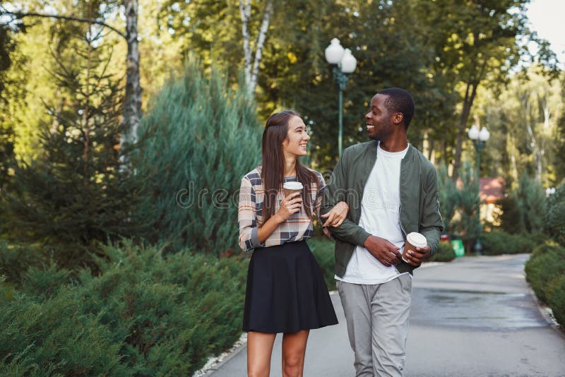 Multiethnic couple in love walk in park royalty free stock photography Multiethnic couple in love walk in park royalty free stock photography