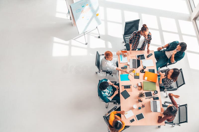 Multiethnic diverse group of business coworkers in team meeting discussion, top view modern office with copy space