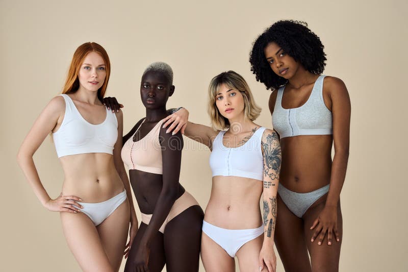 Multi-ethnic group of beautiful women posing in underwear in a beauty  studio - Multicultural fashion models